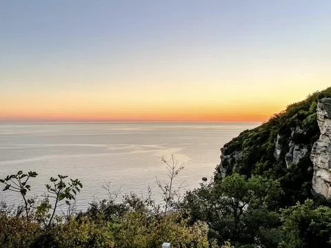 Experience a breathtaking sunset view over the tranquil waters, accompanied by Stock Photos