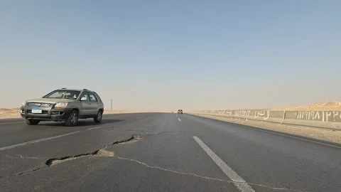 Experience calm desert drive along Cairo Fayoum Desert Road endless road scenery Vidéo 329838696