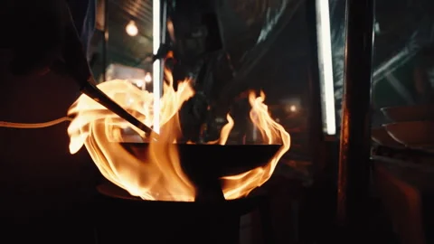 Experience the captivating art of Dynamic Fire Cooking showcased at a Street Stock Footage 303870019