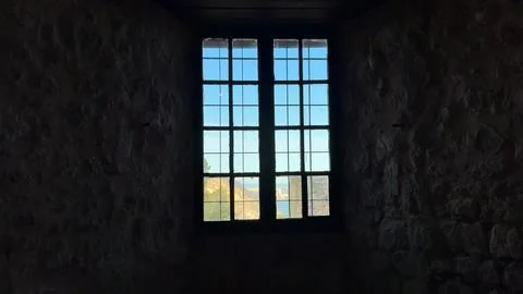 Experience a captivating view that unfolds through a beautifully historic window Stock Photos