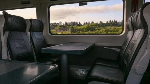 Experience a Comfortable Train Interior Featuring Breathtaking Scenic Views That Foto stock