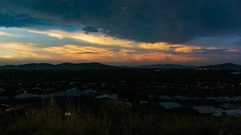 Experience the Dramatic Sunset Over the Hills with a Stunning Urban Landsca.. Stock Photos