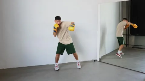 Experience dynamic boxing training at a modern gym with a skilled athlete Stock Footage 312383793