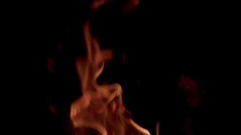 Experience dynamic flames on a dark background, showcasing captivating fire moti Stock Photos