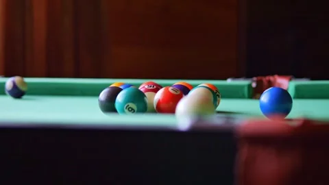 Experience excitement as numbered balls scatter across billiard table from Stock Footage 265585302