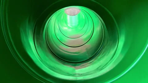 Experience the Green Slide Tunnel, a thrilling attraction for fun and joyful Stock Footage 307728019