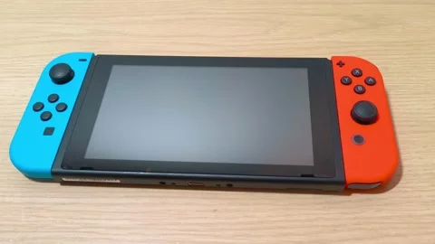 Experience immersive gaming on the go with a modern portable console, perfect Video stock 318310986