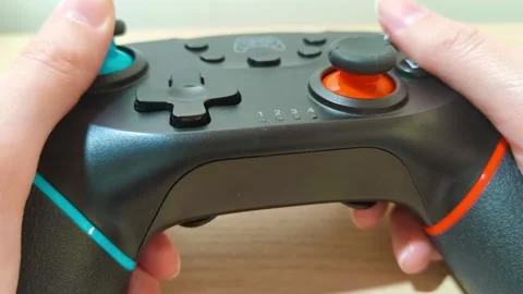 Experience immersive gaming with hands gripping the modern game controller, 動画素材 318310882