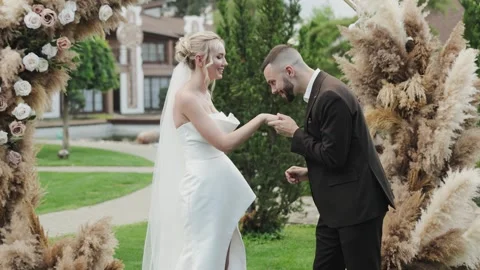 Experience the joy of a beautiful wedding as a bride and groom exchange vows and Stock Footage 322051535