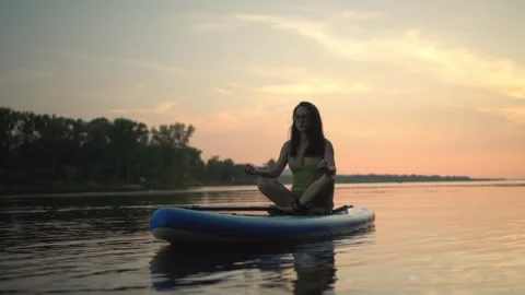 Experience the joy of meditative paddleboarding while watching the stunning Stock Footage 281450928