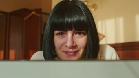 Experience the joys of working from home with this video, as a young woman uses Stock Footage 237141077