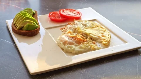 Experience the magic as aromatic spices gently cascade onto a morning omelette Stock-Footage 270033530