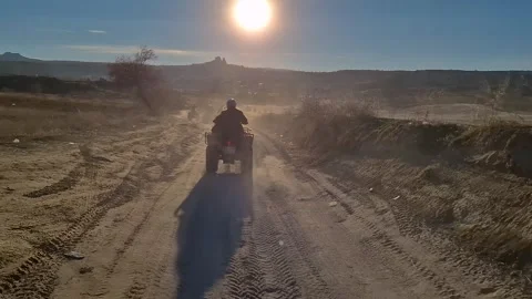 Experience the magic of a quad ride at sunset in Cappadocia. Video stock 262889822