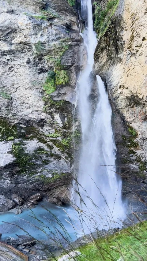 Experience the Majestic Waterfall Cascading Gracefully Down the Rocky Terrain of Stock Footage 307425510
