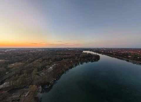 Experience a mesmerizing Scenic River View at Dusk that features Vibrant Sunset Stock Photos