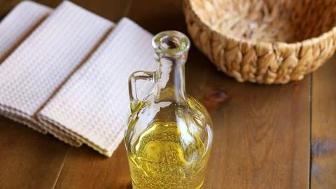 Experience mesmerizing sight of plant based oil slowly pouring into glass bottle Foto stock