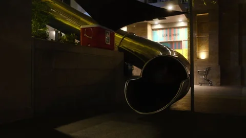 Experience nighttime fun with an illuminated slide in the city Stock Footage 307932815