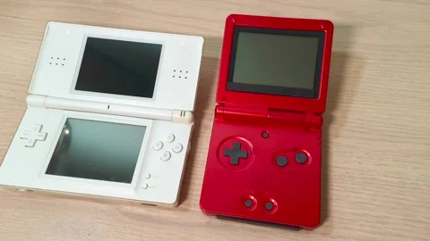 Experience nostalgic gaming with a vibrant red and classic white handheld Video stock 318310948