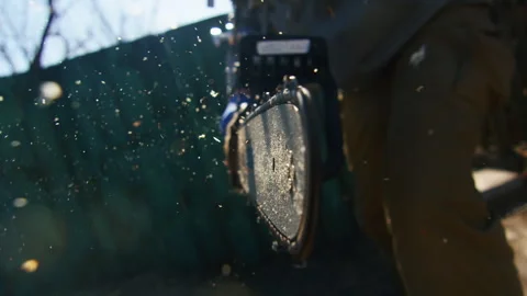 Experience the power and precision of a chainsaw in the hands of a skilled man Stock Footage 264931290