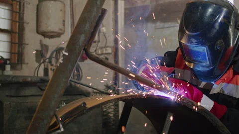 Experience the power of technology and craftsmanship as a welder works with Stock Footage 244448709