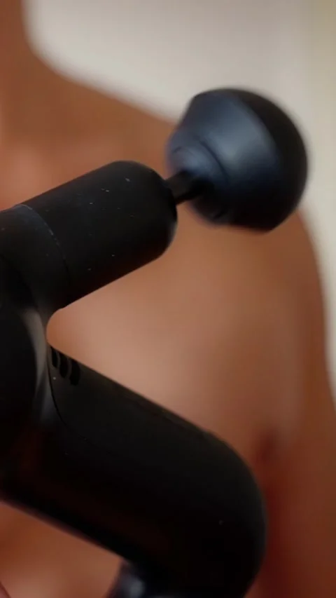 Experience a practical demo of a muscle massage gun for effective pain relief Stock Footage 309245359
