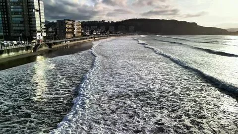 Experience the Serene Beach Waves at Sunset in all their tranquil beauty an.. Stock Photos