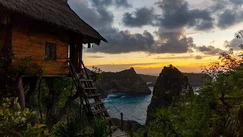 Experience the Serene Beachside Sunset while staying in an Elevated Cabin by the Stock Photos