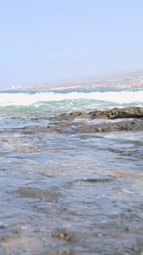 Experience the serene coastal waters and rocky shoreline, a breathtaking escape Stock Footage 318620280