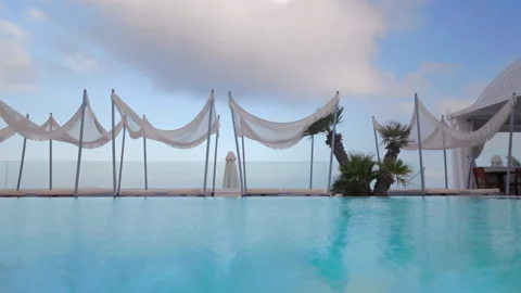Experience the Serene Infinity Pool with a stunning Ocean View and Elegant Stock Footage 315318313