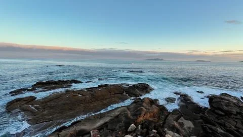 Experience a Serene Ocean View Featuring a Rocky Shoreline Beautifully Illu.. Stock Photos
