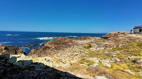 Experience a serene ocean view, featuring a rocky coastline and beautifully.. Stock Photos