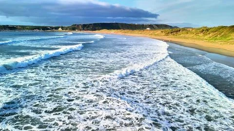 Experience the Serene Ocean Waves at Sunset on a Beautiful and Tranquil Beach Stock Photos