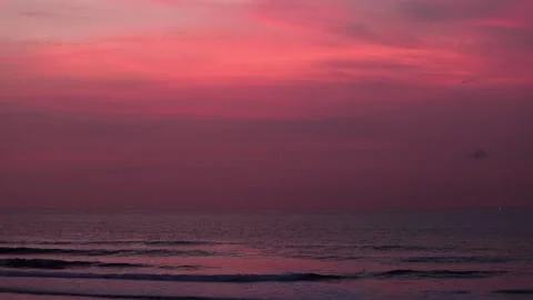 Experience the Serene Sunset Casting Beautiful Colors Over the Still and Calm Stock Footage 321374606