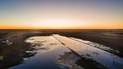 Experience the Serene Sunset Over Tranquil Waterways Amidst a Vast and Beau.. Stock Photos