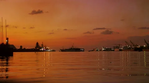 Experience a serene sunset over water, with vibrant sky colors Stock Footage 317049953