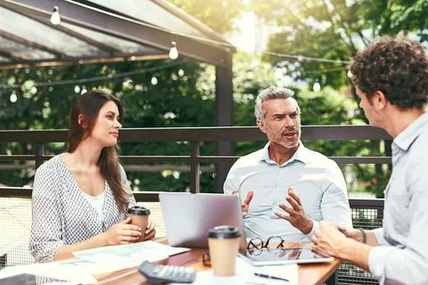 Experience, the source of all knowledge. Shot of a team of colleagues using a Stock Photos