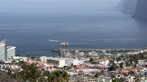 Experience the stunning coastal view with a beautiful harbor and ship in the Stock Footage 317074859