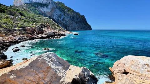 Experience the stunning coastal view featuring clear blue waters and Stock Photos