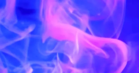 Experience a stunning journey through blue and purple smoke on a dark backdrop.  Stock Footage 295933371