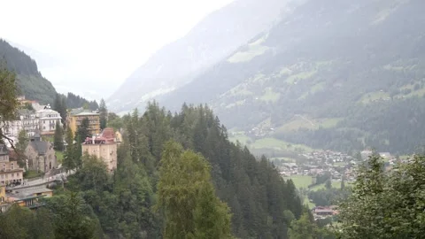 Experience a stunning mountain view with a picturesque European village in Stock Footage 292800906