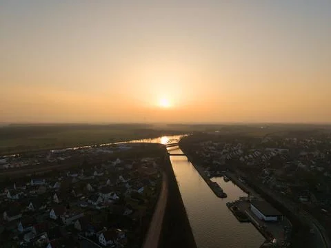 Experience a stunning river sunset casting a warm glow over a tranquil Stock Photos
