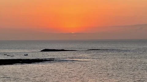 Experience a Stunning Sunset Over the Tranquil Ocean Waters on a Peaceful Stock Photos