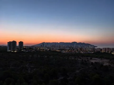 Experience a Stunning Sunset View Over a Picturesque Coastal Cityscape and .. Photos