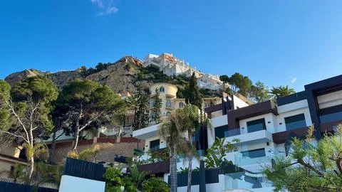 Experience the Stunning View of Exceptional Hillside Architecture Beneath a.. Stock Photos