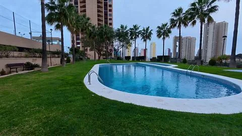 Experience a Stylish Poolside View Featuring Beautiful Palms and Impressive.. Stock Photos