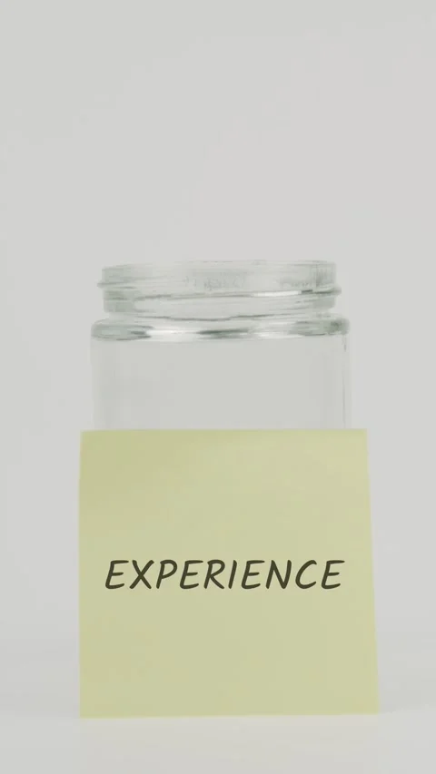 Experience text or word on yellow sticky note attached to glass jar Stock Footage 311730107