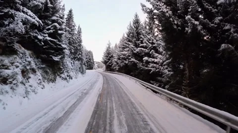Experience the thrill of driving on a winter road in Lofoten, Norway, surrounded Video stock 258697970