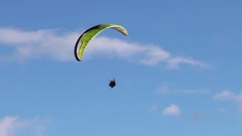 Experience the thrill of dual or tandem paragliding as you indulge in slow turns Stock Footage 128457247