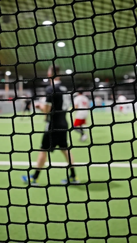 Experience the thrill of Indoor Soccer Action from behind the net during intense Stock Footage 318846386