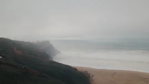 Experience the thrill of nazare big waves in portugal's atlantic ocean Stock Footage 321474435